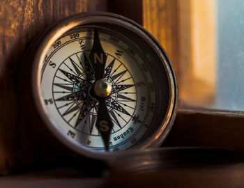Compass leaning against window frame