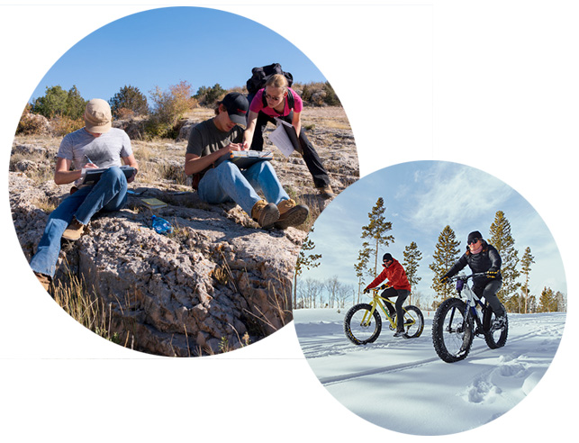Students on rocks studying and snow bikers