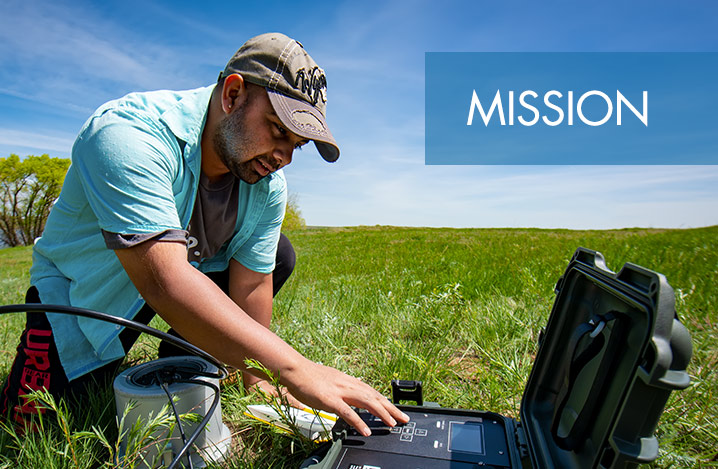 Mission with student working on device in the field