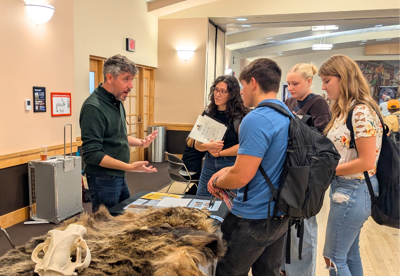 Photo of College of Education students talking to Jeremy Thornbrugh from Wyoming State Museum.