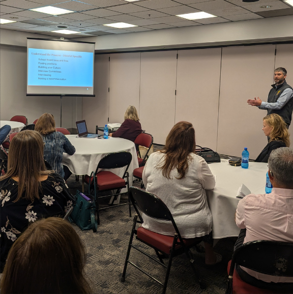 Photo of Superintendent Chase Christensen leading a principal mentor workshop.