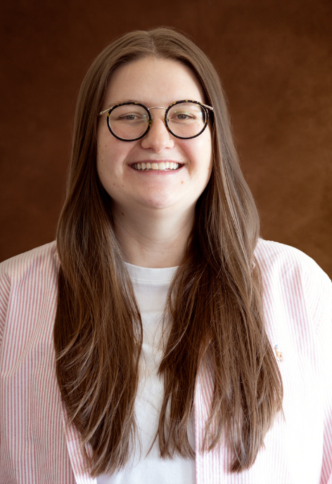 Kyra Wright, wearing a pink and white stripped jacket with a white shirt.