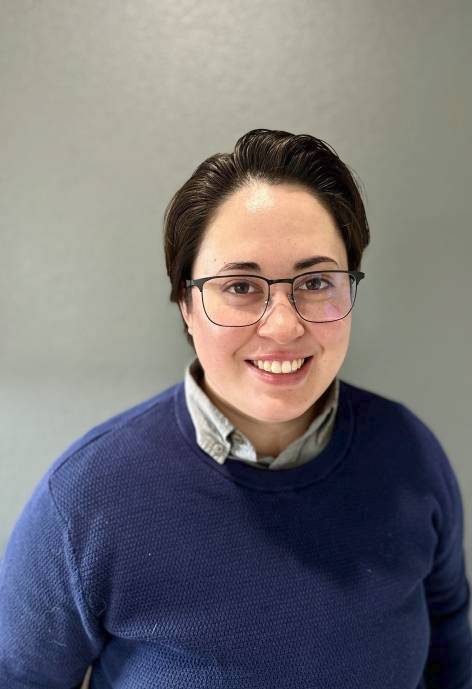 Tris Vandermeade, wearing a blue sweater over a light grey button-up.