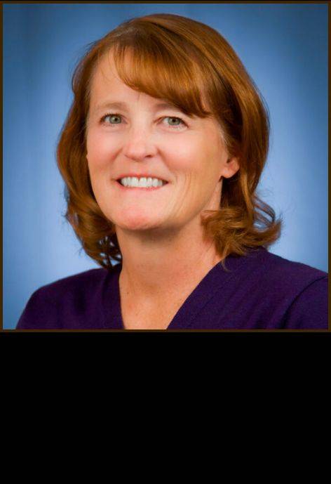 Dr. Danae Stampfli, wearing a dark purple blouse.