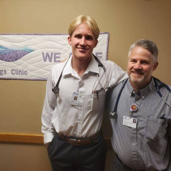 Two people standing together in a clinic.