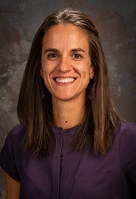 Danielle Bruns, wearing a dark purple blouse.