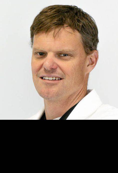 Lars Peterson, wearing a white doctor's coat.