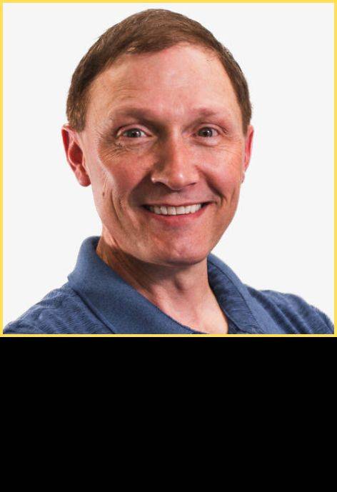 Dr. Darren Mikesell, wearing a dark blue collared polo shirt.