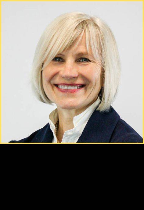 Dr. Daiva Olipra, wearing a black suit jacket and a white blouse.