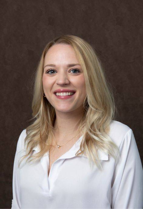 Shayna Bauer, wearing a white blouse.