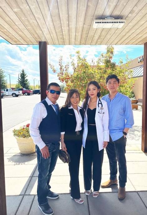 Anh with three of her family standing outside.