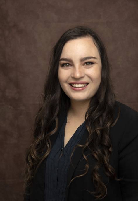 Tatiana Smith wearing a black jacket and a dark blue blouse.