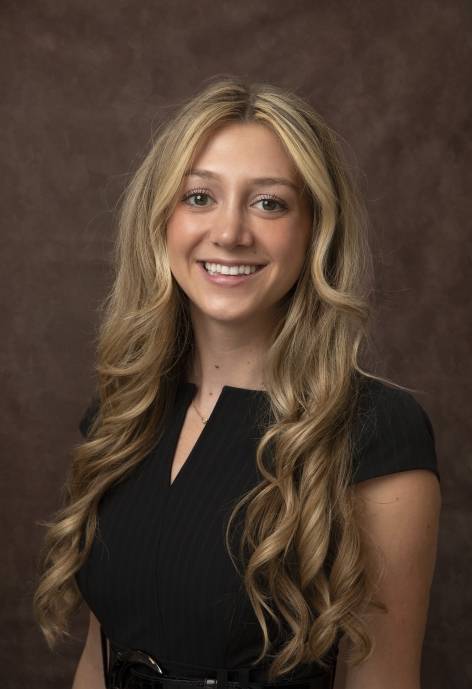 Anna Ujvary wearing a black blouse.