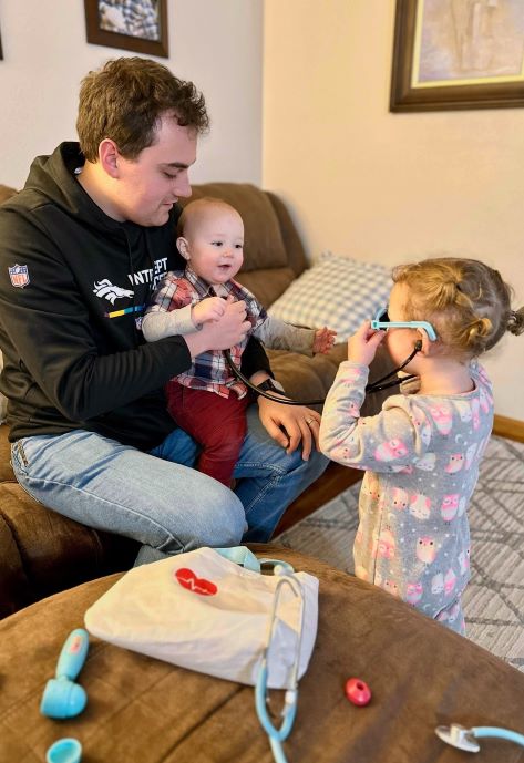 Caden with his two children playing.