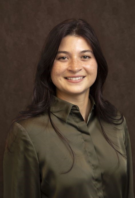 Cassidy Dellos wearing a dark bronze button-up shirt.