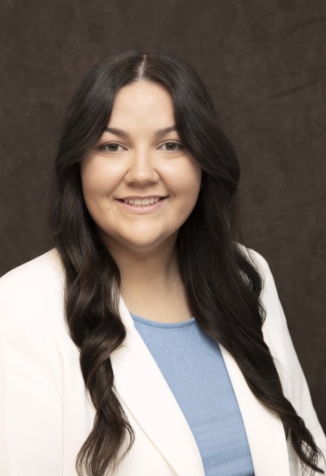 Celeste Keelin wearing a white jacket and a blue blouse.