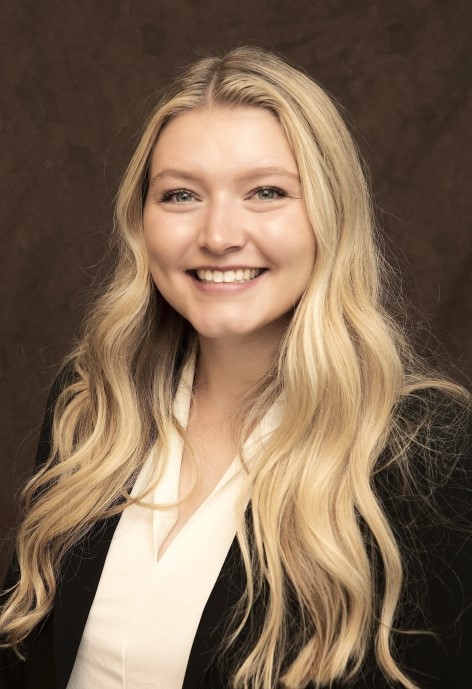 Aedian O'Connor wearing a black jacket and white blouse.