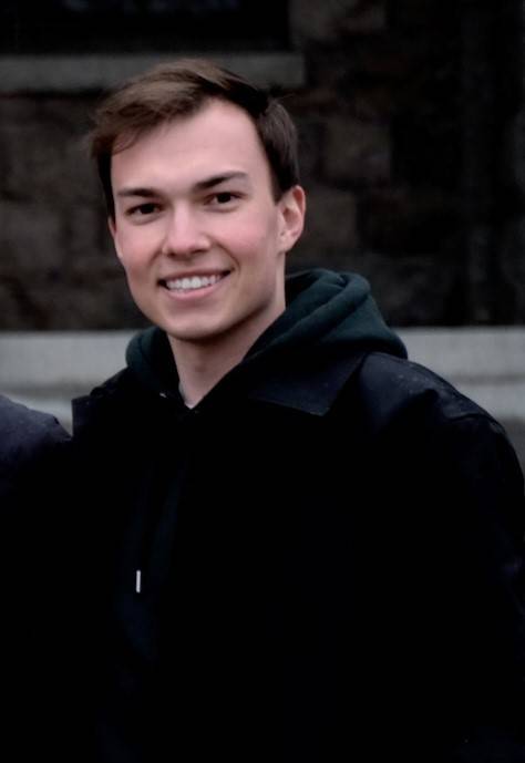 Tim standing outside and smiling at the camera.