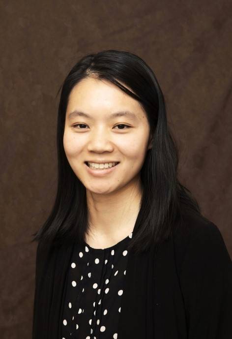 Lulu Rochelle wearing a black cardigan and a black and white polka-dot blouse