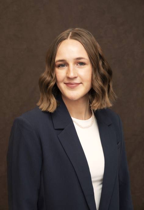 Annika Syvrud wearing a blue suit jacket and a white blouse.