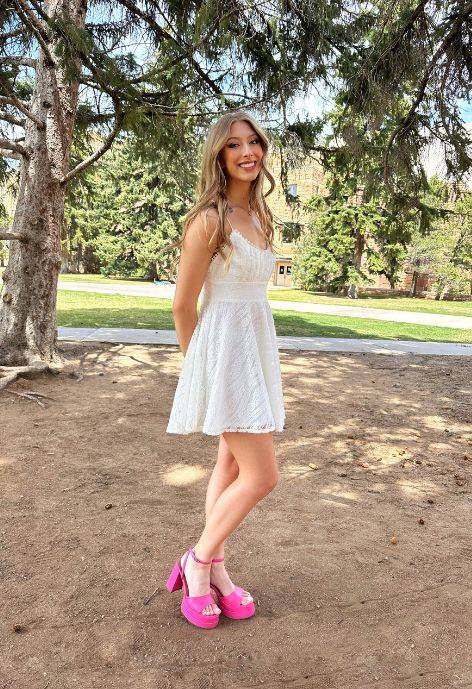 Erica standing outside under a pine tree on UW's main campus.