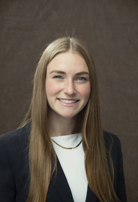 Rachael Harrower wearing a black jacket and a white blouse.