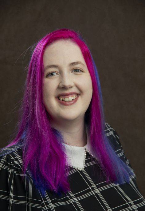 Samantha Johnson wearing a black plaid blouse.