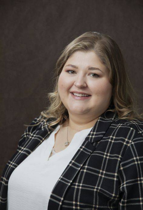 Linsey Lancaster wearing a black plaid jacket and white blouse.