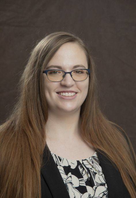 Gabrielle Reimann wearing a black blaszor and a white and black floral patterned blouse.