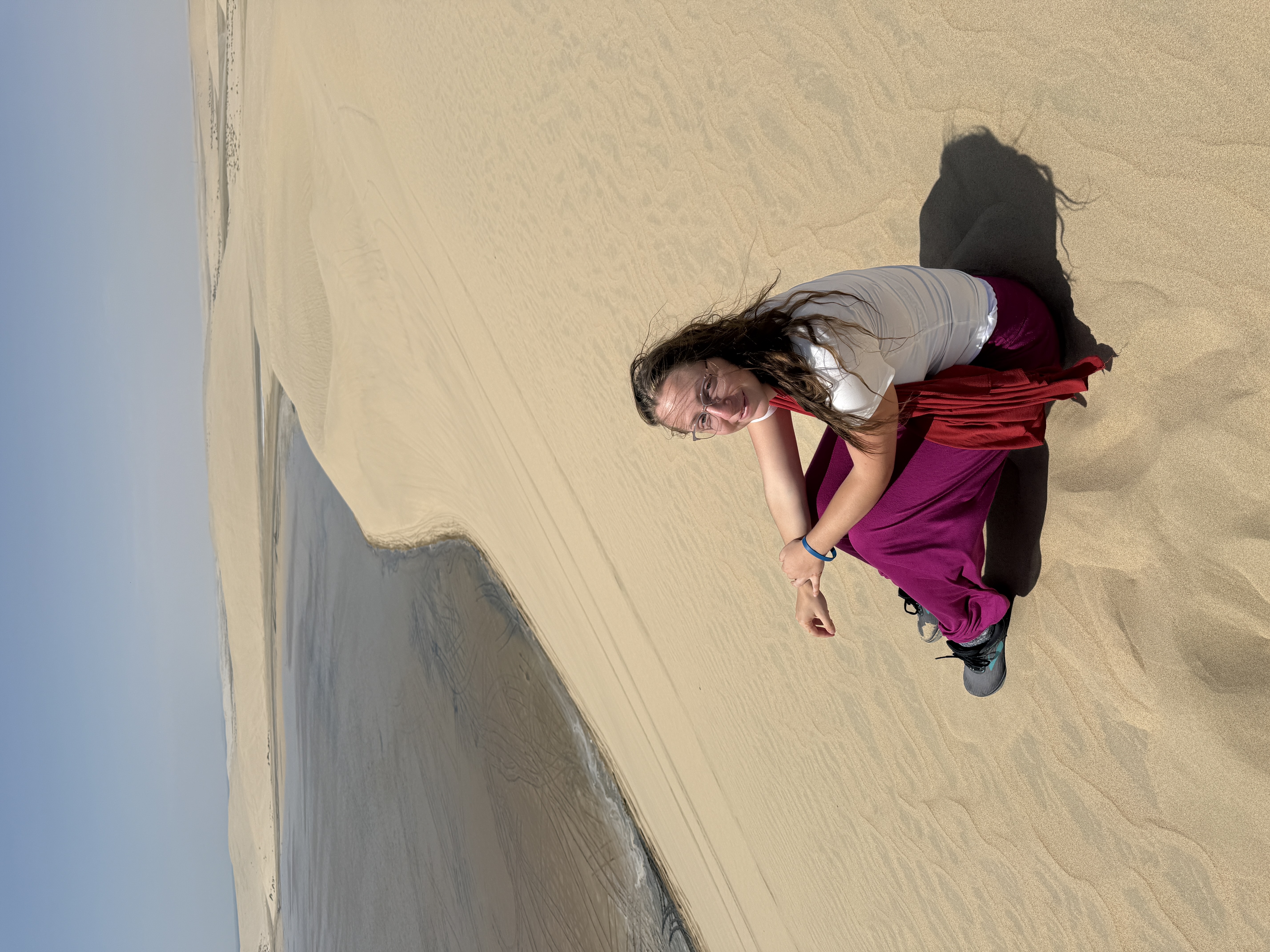 woman sitting on a sand dune