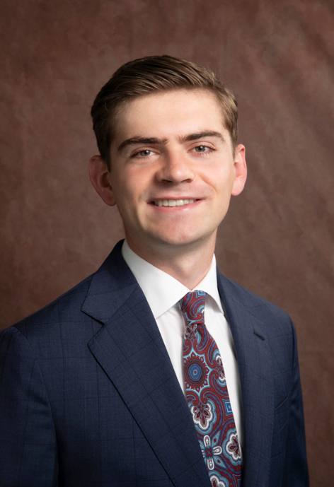 bradshaw wearing a navy suit and tie