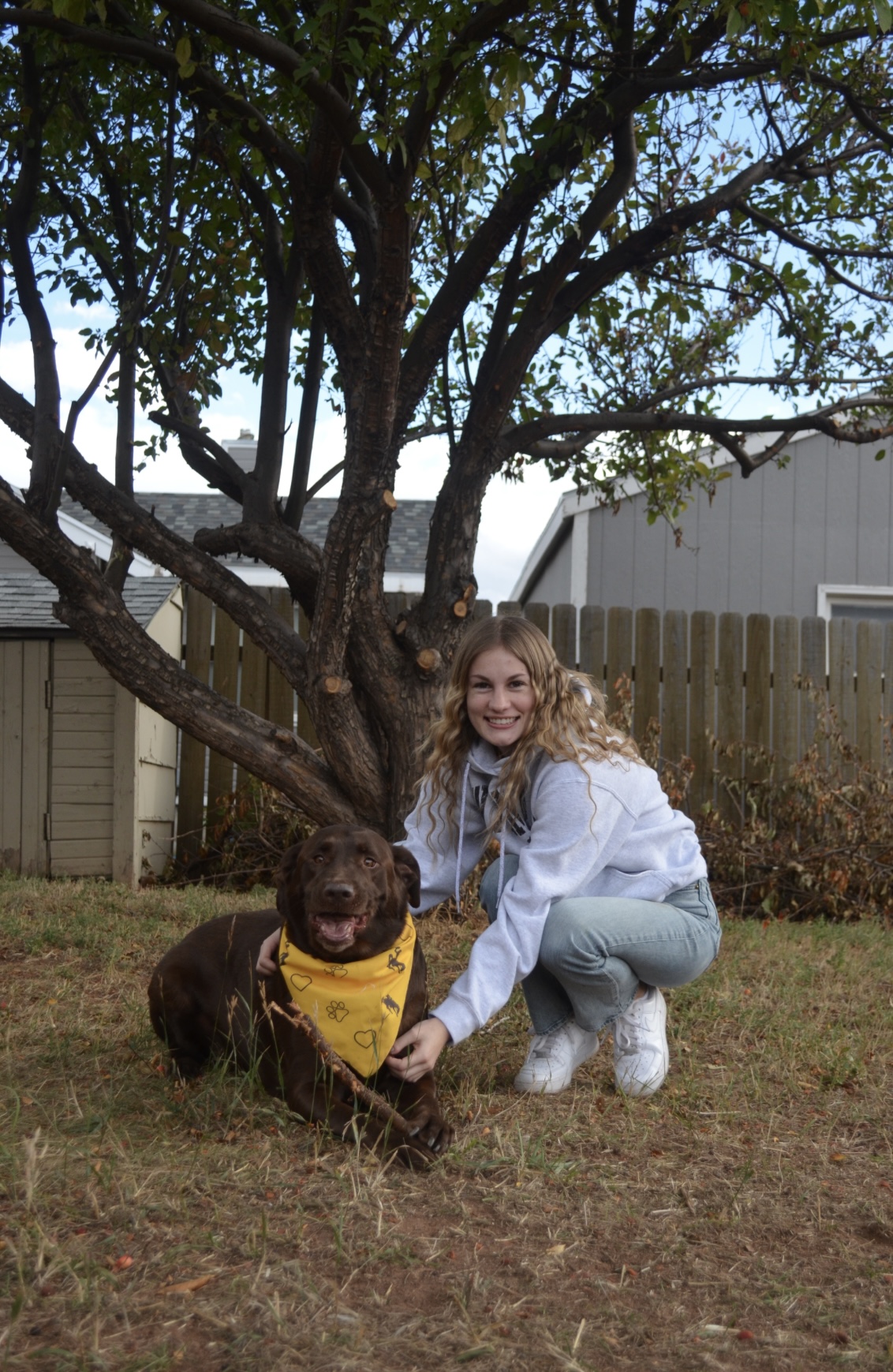robyn posing with a brown dog