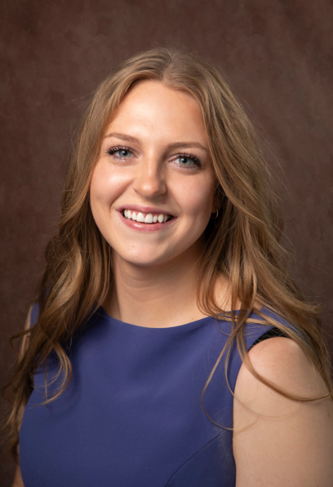 sydney wearing a blue blouse