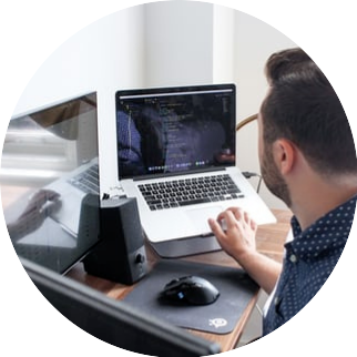 A persone working on a laptop.