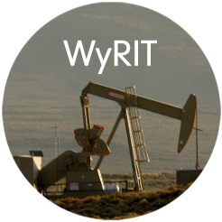 Oil well with a hazy landscape in the background.