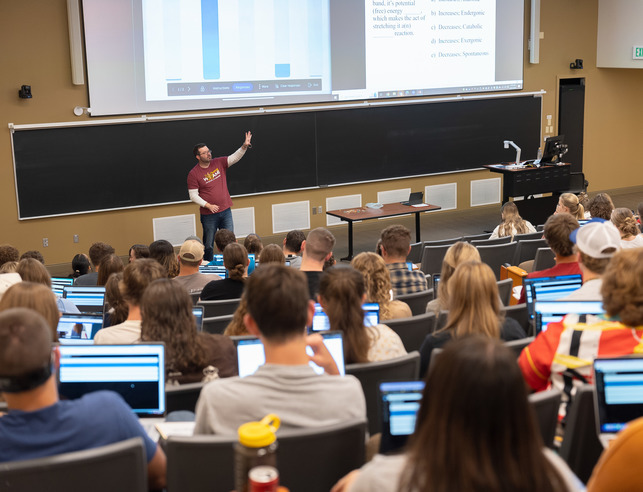 Photo of students in a class watching an instructor.