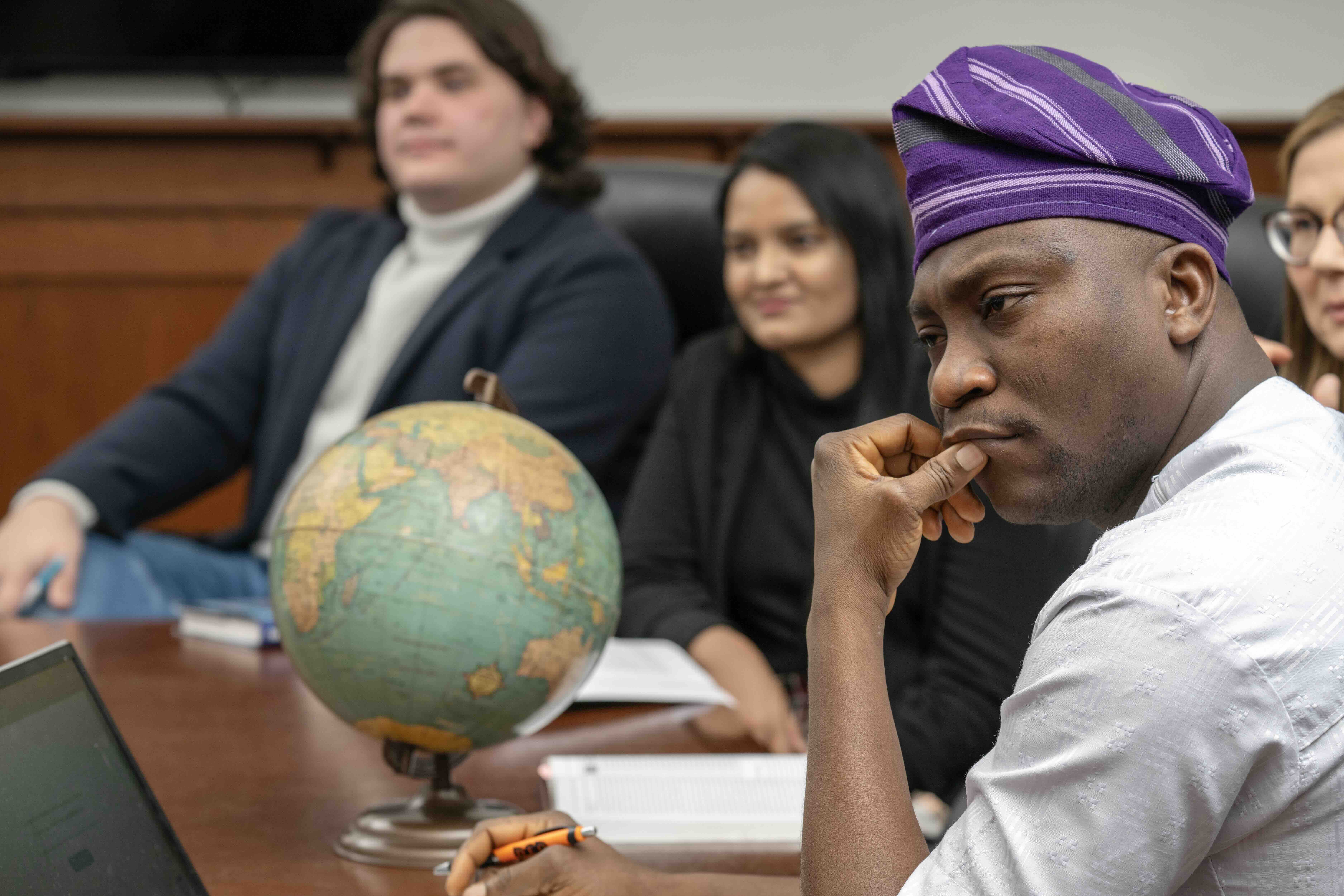 Picture of students in class listening intently.