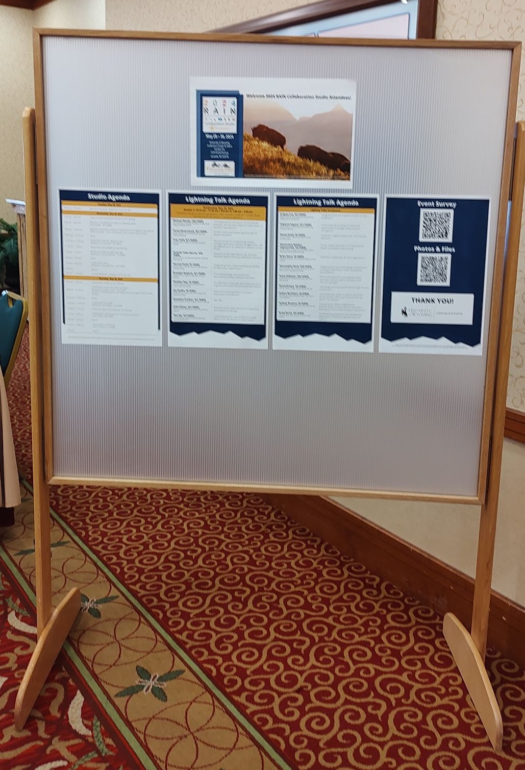 INBRE poster board stand assembled and displaying a conference agenda