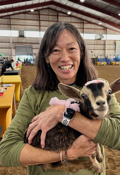 Photo of Annie Bergman holding a baby goat