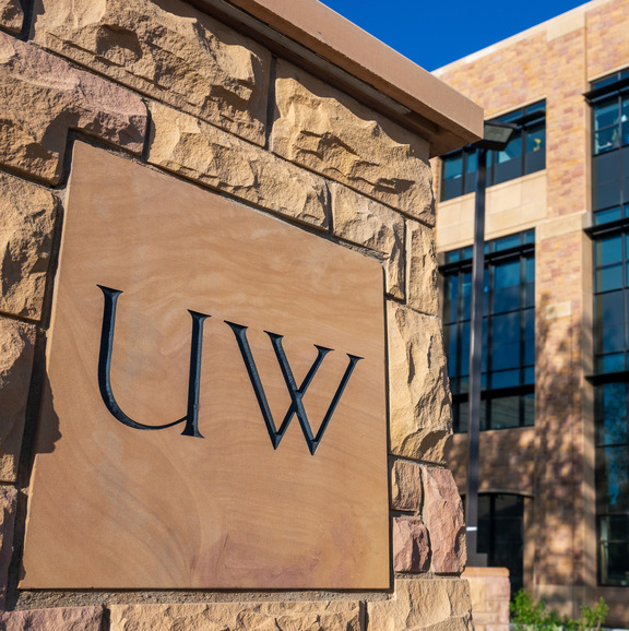 UW engraved stone in front of campus building 