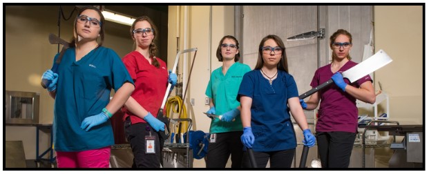 girls on necropsy floor of WSVL holding various cutting instruments