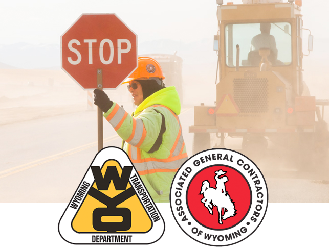 Flagger in front of tractor with Wyoming Transportation Department and Associate General Contractors of Wyoming logos