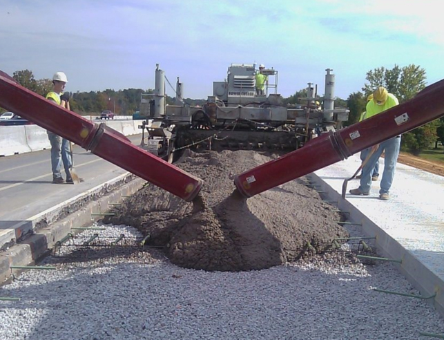 Road construction crew pouring concrete