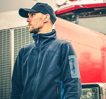 Truck driver standing in front of semi-truck