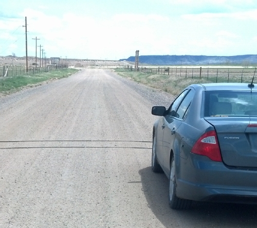 pneumatic traffic counter tubes set on a gravel road.