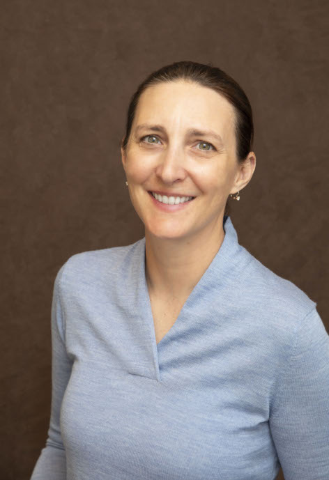 A headshot of Amy Navratil wearing a blue shirt.