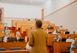 A professor speaks to a room of students