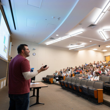 A speaker teaches an audience in a classroom