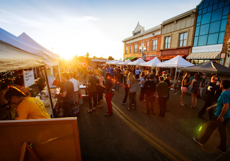 A group of people walk around a festival